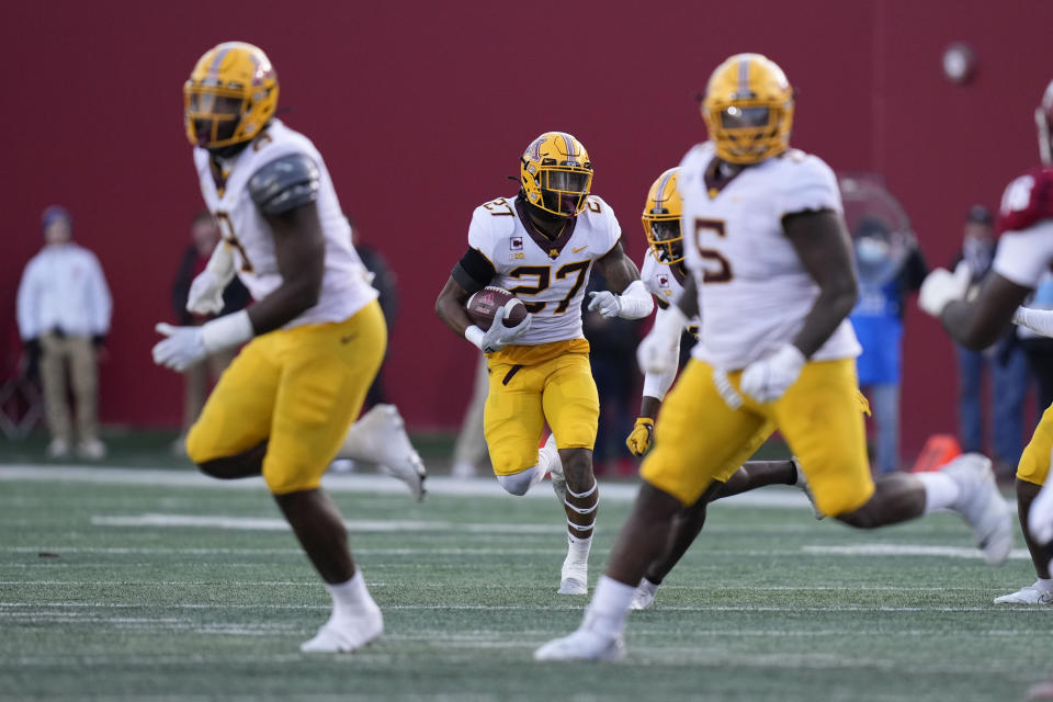 Minnesota defensive back Tyler Nubin (27) runs back an interception in the first half during an NCAA college football game against Indiana in Bloomington, Ind., Saturday, Nov. 20, 2021. (AP Photo/AJ Mast)