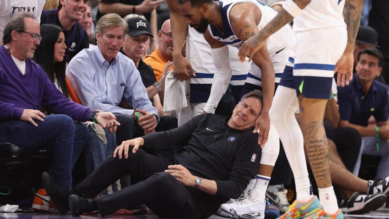 <div>Head coach Chris Finch of the Minnesota Timberwolves grabs in leg in pain after a collision with Mike Conley #10 during the second half of game four of the Western Conference First Round Playoffs against the Phoenix Suns at Footprint Center on April 28, 2024 in Phoenix, Arizona. The Timberwolves defeated the Suns 122-116 and win the series 4-0.</div>