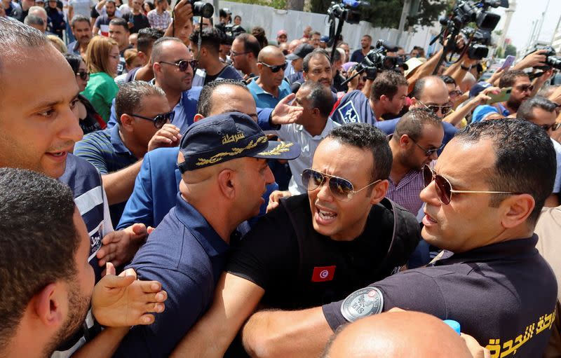 Police members push back supporters of Tunisia's Islamist opposition party Ennahda protesting in Tunis