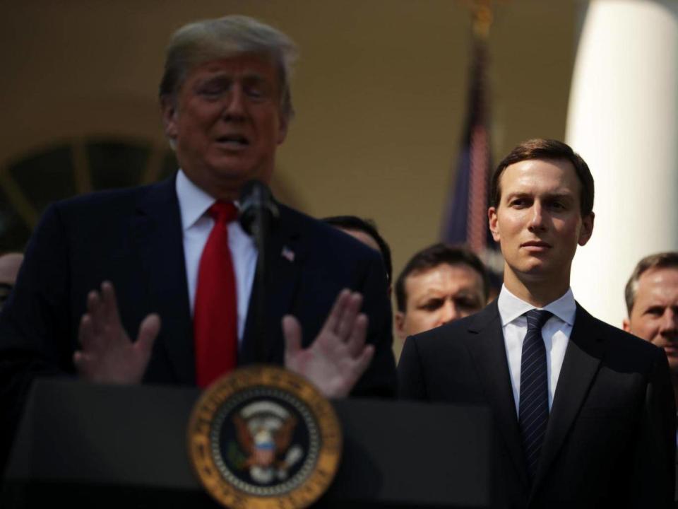 Jared Kushner listens as his father-in-law speaks (Getty)