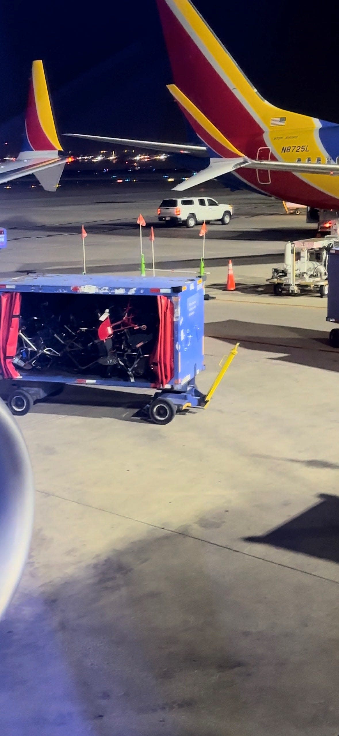 Wheelchair frames on a baggage cart in Richmond.