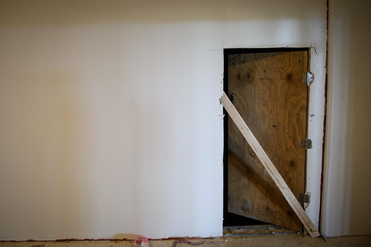 A busted door opens to an elevator shaft on the fifth floor of the Hay Street parking deck.