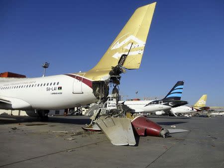 A damaged aircraft is pictured after shelling at Tripoli International Airport August 24, 2014. REUTERS/Aimen Elsahli