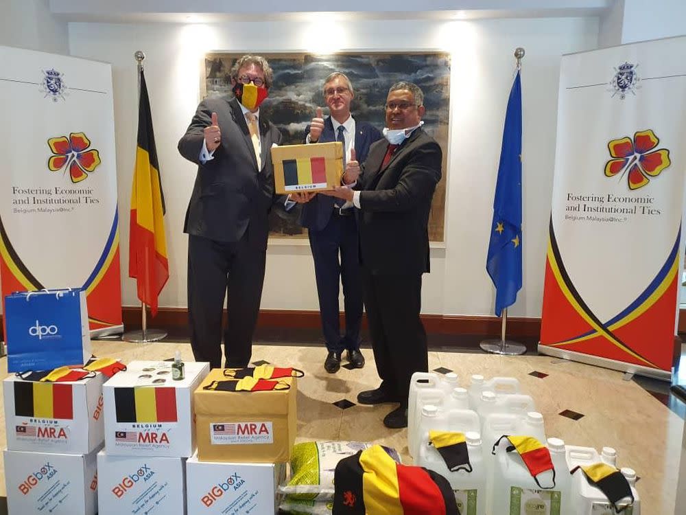 Belgium ambassador to Malaysia Pascal H. Grégoire (left) hands over food aid to Malaysian Relief Agency president Dr Mohd Daud Sulaiman. Looking on is UNHCR representative Thomas Albrecht. — Picture courtesy of Malaysian Relief Agency