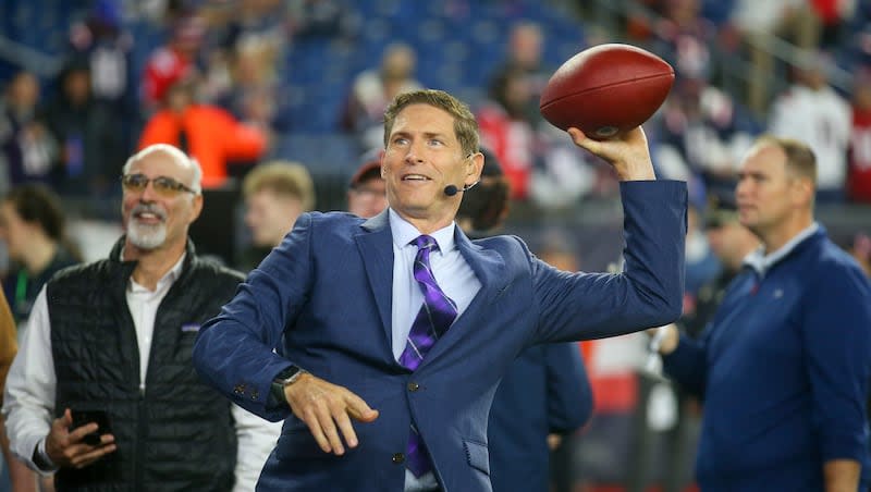 Former NFL quarterback and football analyst Steve Young throws a ball to a fan prior to an NFL football game between the Chicago Bears and New England Patriots, Monday, Oct. 24, 2022, in Foxborough, Mass.