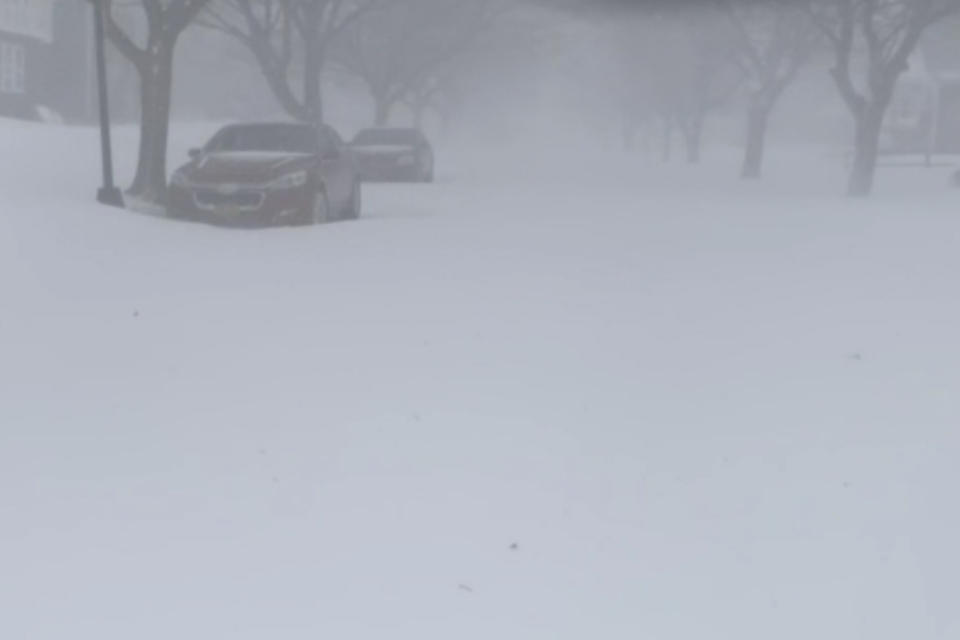 High winds and snow covers the streets and vehicles in Buffalo, N.Y. on Sunday, Dec. 25, 2022. Millions of people hunkered down in a deep freeze overnight and early morning to ride out the frigid storm that has killed at least 20 people across the United States, trapping some residents inside homes with heaping snow drifts and knocking out power to several hundred thousand homes and businesses.(WKBW via AP)