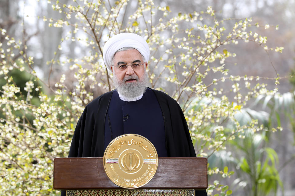 In this photo released on Friday March 20, 2020 by the official website of the office of the Iranian Presidency, President Hassan Rouhani delivers a message for the Iranian New Year, or Nowruz, in Tehran, Iran. Supreme Leader Ayatollah Ali Khamenei and President Hassan Rouhani in separate new year messages vowed to overcome the new coronavirus and increase economic growth. (Iranian Presidency Office via AP)