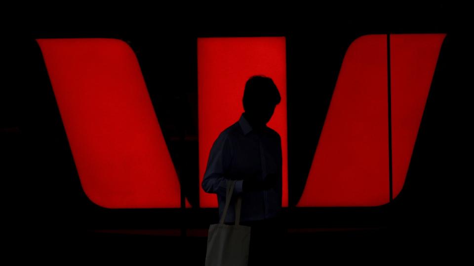 A pedestrian walks past Westpac Banking Corp. logo at Westpac.