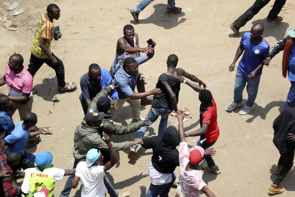 A fight breaks out among Leo and Nubi community members during a mass rally called by the opposition leader Raila Odinga over the high cost of living in Kibera Slums, Nairobi, Monday, March 27, 2023. Police in Kenya are on high alert ahead of the second round of anti-government protests organized by the opposition that has been termed as illegal by the government. Police chief Japheth Koome insists that Monday's protests are illegal but the opposition leader Raila Odinga says Kenyans have a right to demonstrate.(AP Photo/Brian Inganga)