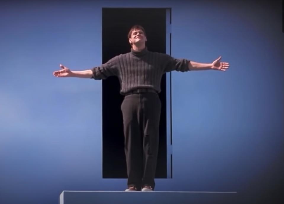 Truman finishes a bow before walking through the exit door in "The Truman Show"