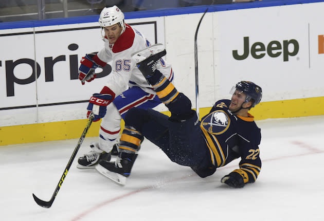 Buffalo Sabres Johan Larsson (22) is tripped up by Montreal Canadiens Andrew Shaw (65) during the first period of a NHL hockey game, Thursday, Oct. 13, 2016, in Buffalo, New York. (AP Photo/Jeffrey T. Barnes)