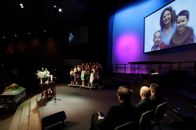 A photo of Susan Cox Powell and her sons Charlie Powell (R) and Braden Powell (L) displayed at Charlie and Braden's funeral