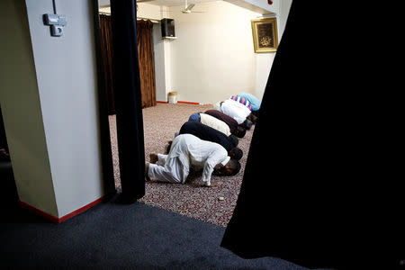 Muslim men attend Eid al-Fitr prayers at a makeshift mosque in a basement, to mark the end of the holy month of Ramadan, in Piraeus, near Athens, Greece July 6, 2016. REUTERS/Alkis Konstantinidis