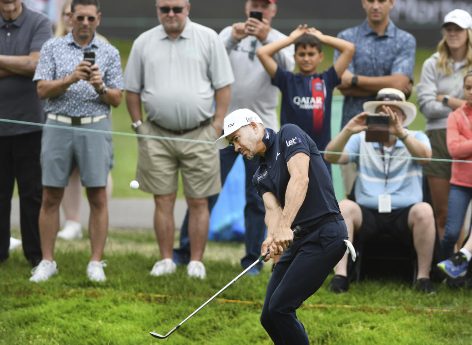 Camilo Villegas hits out of the rough onto the 18th green during the second round of the Rocket Mortgage Classic golf tournament at the Detroit Golf Club in Detroit, Michigan, Friday, June 27, 2024. (Daniel Mears/Detroit News via AP)