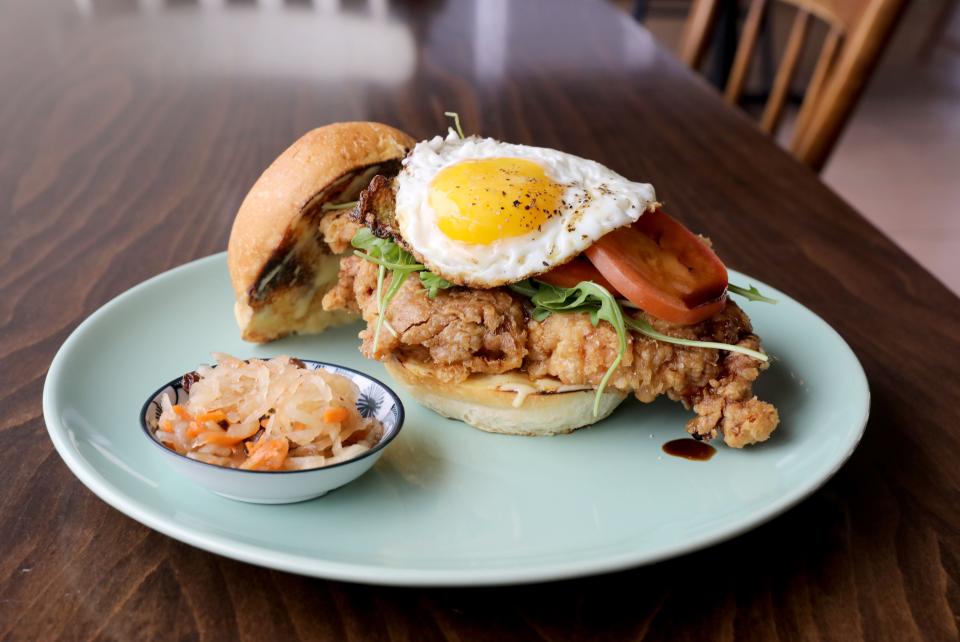 The Fried Crispy Chicken Sandwich, marinated in ginger and lime, with a sweet soy drizzle, calamansi mayo and a fried egg, and atsara (pickled green papaya) at Karenderya restaurant on Main Street in Nyack, Jan. 16, 2019.