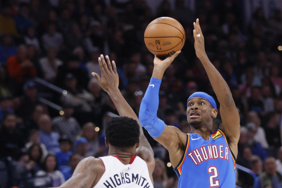 Oklahoma City Thunder guard Shai Gilgeous-Alexander (2) prepares to shoot over Miami Heat forward Haywood Highsmith, left, during the second half of an NBA basketball game Friday, March 8, 2024, in Oklahoma City. (AP Photo/Nate Billings)