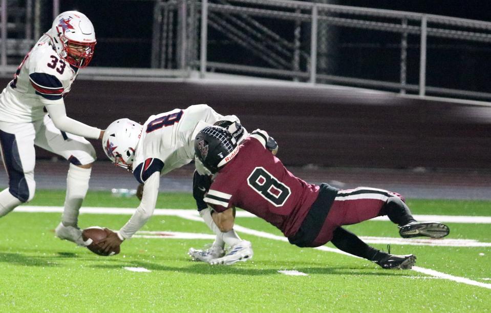 Elmira's Brady Keefe (8) sacks Binghamton quarterback Musiah Young and forces a fumble recovered by the Express during a 44-22 win in a Section 4 Class AA football semifinal Nov. 4, 2022 at the Thomas J. Hurley Athletic Complex at Elmira High School.