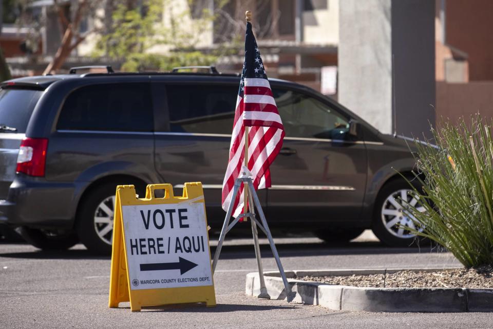 A "Vote here" sign is seen at an early voting location on Oct. 14, 2020, at Southern Plaza in Phoenix.