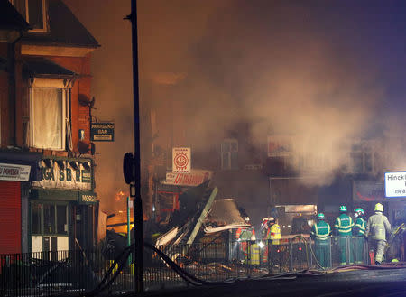 Members of the emergency services work at the site of an explosion which destroyed a convenience store and a home in Leicester, Britain, February 25, 2018. REUTERS/Darren Staples