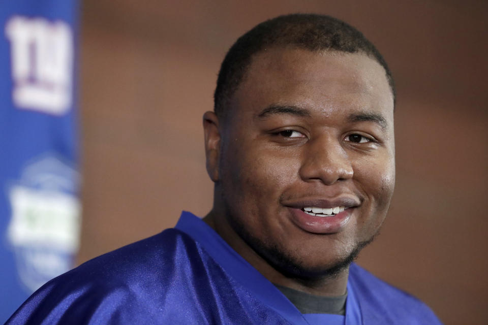 FILE - New York Giants first round draft pick Dexter Lawrence talks to reporters during NFL football rookie camp, Friday, May 3, 2019, in East Rutherford, N.J. Lawrence has the simplest of goals for his second season with the Giants. The second of three Giants’ first-round draft picks in 2019 wants to be noticed in the fourth quarter of games this season. He started all 16 games in 2019 and finished with 38 tackles, 2 1/2 sacks, a forced fumble and nine quarterback hits on a 4-12 team. Talking to the media Tuesday, Aug. 18, 2020 for the first time since camp opened, Lawrence wasn't satisfied with his first NFL season. (AP Photo/Julio Cortez)