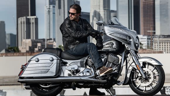 Rider on an Indian Motorcycle Limited Edition Chieftain Elite, with cityscape in background.