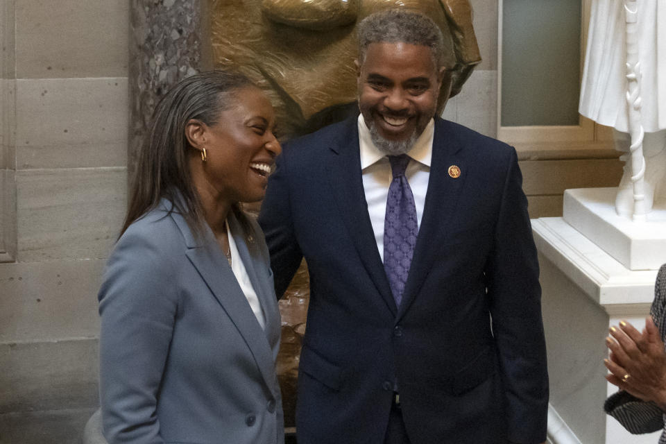 Sen. Laphonza Butler, D-Calif., left, reacts after being sworn into the Congressional Black Caucus by Rep. Steven Horsford, D-Nev., right, in front of a statue of Rosa Parks in the Hall of Statuary on Capitol Hill, Tuesday, Oct. 3, 2023 in Washington. (AP Photo/Mark Schiefelbein)