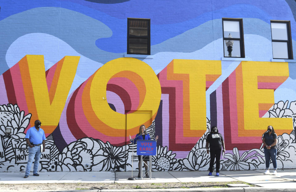 Michigan Secretary of State Jocelyn Benson speaks in front of a newly-painted mural by artist Ndubisi Okoye, during a press conference by MichiganVoting.com Coalition members announcing "40 Days of Early Voting" campaign at the ACLU of Michigan building in Detroit, Thursday, Sept. 24, 2020. (Daniel Mears/Detroit News via AP)