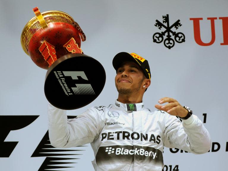 Mercedes AMG Petronas driver Lewis Hamilton holds his trophy after winning the Formula One Chinese Grand Prix, in Shanghai, on April 20, 2014