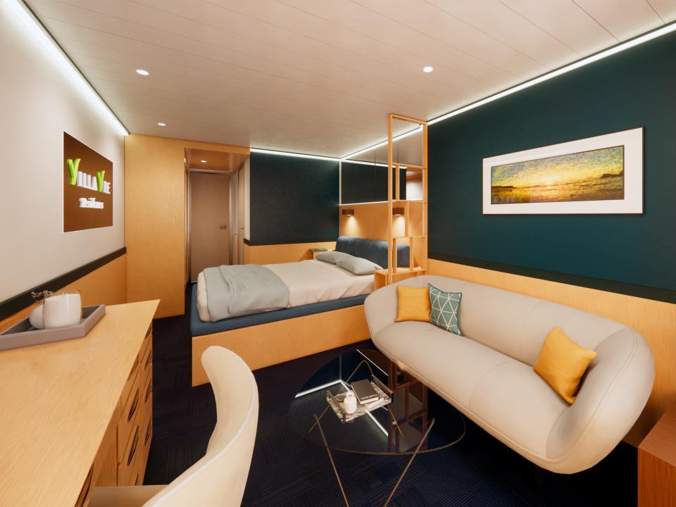 A rendering of a stateroom on Villa Vie's cruise ship with a bed, couch, tables.