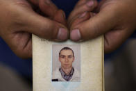 Nina Bilyk holds a photo of her partner, Ivan Fartukh, at their home Saturday, Aug. 13, 2022, where he was killed in a Russian rocket attack last night in Kramatorsk, Donetsk region, eastern Ukraine. The strike killed three people and wounded 13 others, according to the mayor. The attack came less than a day after 11 other rockets were fired at the city. (AP Photo/David Goldman)