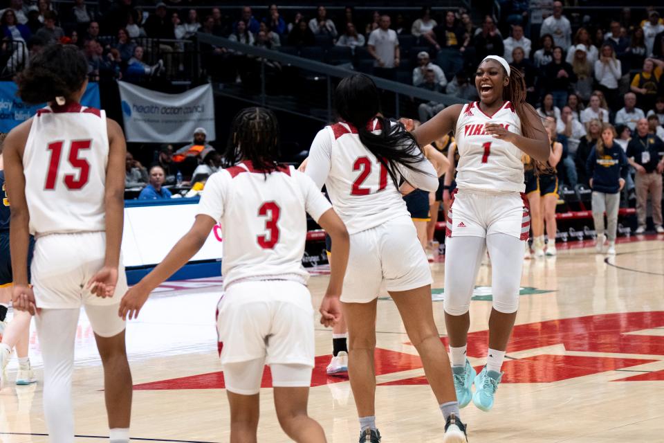 Princeton forward Diawna Carter-Hartley (1) celebrates with Princeton forward Kali Fortson (21), Princeton guard Mari Gerton (3), and Princeton guard Sole Williams (15) after winning the OHSAA Division I state championship game at the University of Dayton Arena in Dayton, Ohio, on Saturday, March 11, 2023. Princeton defeated Olmsted Falls 69-51. 