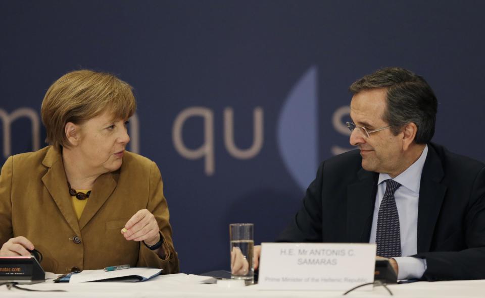 Greece's Prime Minister Antonis Samaras, right, listens German Chancellor Angela Merkel before a meeting with young Greek businessmen in Athens on Friday, April 11, 2014. Merkel arrived for a brief visit, a day after the crisis-hit country returned to international bond markets. Greece this week reached a milestone in the recovery from its financial crisis — it successfully tapped bond markets for the first time since 2010, raising 3 billion euros ($4.14 billion) in five-year debt. (AP Photo/Thanassis Stavrakis)