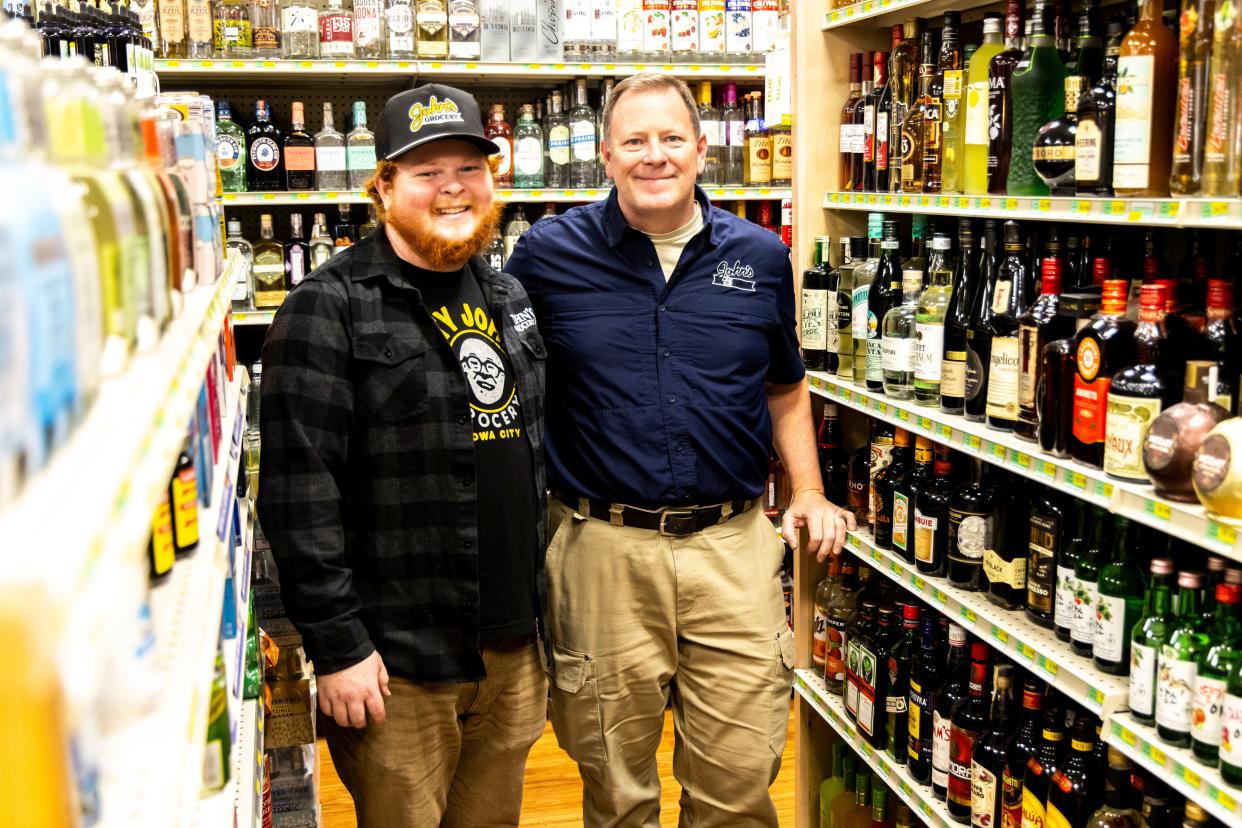 JD and Doug Alberhasky pose for a photo, Thursday, Nov. 9, 2023, at John's Grocery in Iowa City, Iowa.