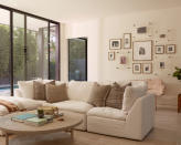 <p> Where better to create a lovely gallery wall of photos than in a living room? </p> <p> In this minimalist living room, designed by Lucie Ayres of 22 Interiors, the family picture wall really takes center stage, with the different styles and shapes of frames making for a welcoming focal point in the space.&#xA0; </p> <p> Framed photographs can not only create a talking point when guests arrive in the room, they can make your space feel more homey, inviting, and connected to you. </p>