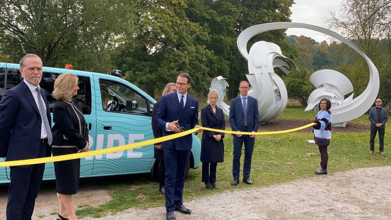 Prince Daniel cuts the ribbon during the showcasing of a self-driving bus by Ericsson and Telia in Stockholm