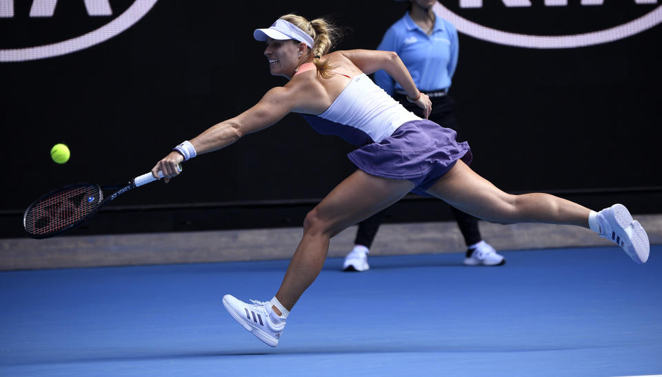 Germany's Angelique Kerber makes a backhand return to Australia's Priscilla Hon during their second round singles match at the Australian Open tennis championship in Melbourne, Australia, Thursday, Jan. 23, 2020. (AP Photo/Andy Brownbill)