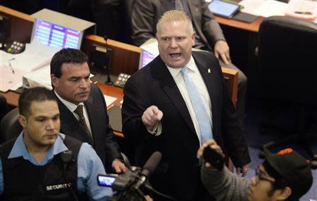 Toronto city councillor Doug Ford (C) reacts to the public gallery during a special council meeting at City Hall in Toronto November 18, 2013. REUTERS/Aaron Harris