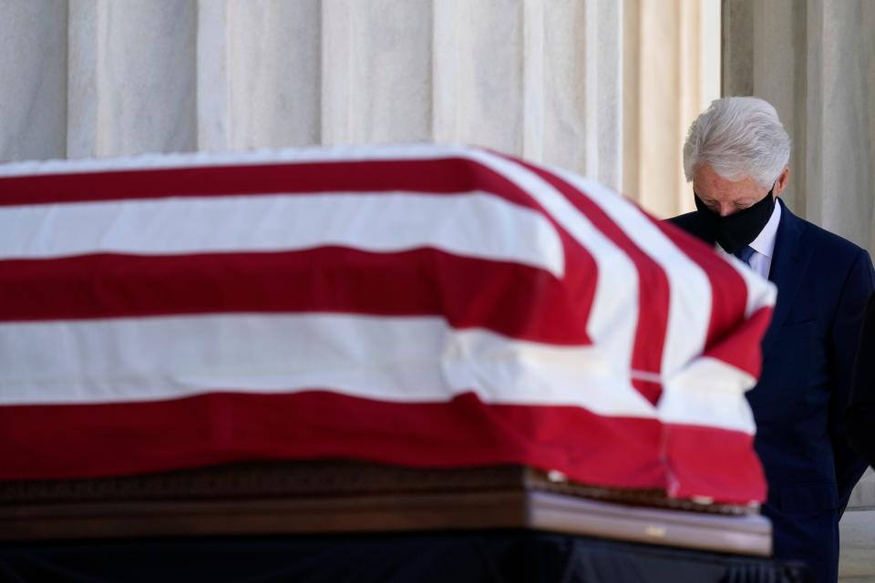 Former President Bill Clinton pays respects as Justice Ruth Bader Ginsburg lies in repose under the portico at the top of the front steps of the U.S. Supreme Court building on Sept. 23.