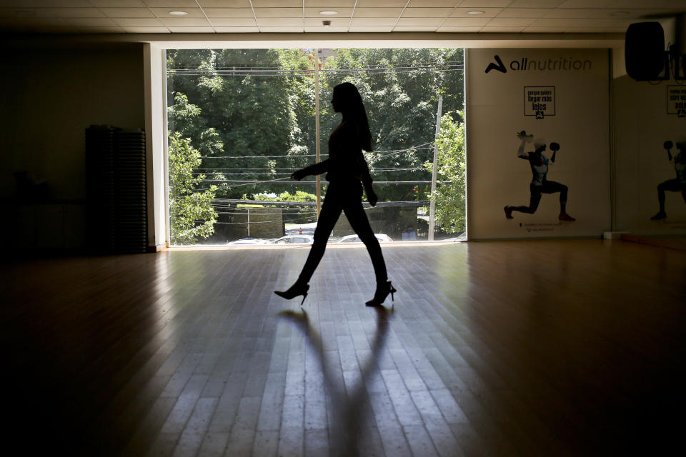 In this Nov. 8, 2018 photo, Venezuelan born Andrea Diaz, Miss Chile, takes part in a runway class in Santiago, Chile, Thursday, Nov. 8, 2018. "I represent the new Chile," the 26-year-old said as she was training at a local gym in Santiago for the upcoming competition. "This is an inclusive country where immigrants come in search of opportunities." (AP Photo/Esteban Felix)