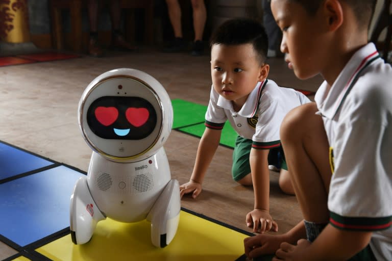 Children watch a Keeko robot at the Yiswind Institute of Multicultural Education in Beijing, where the intelligent machines are telling stories and challenging kids with logic problems