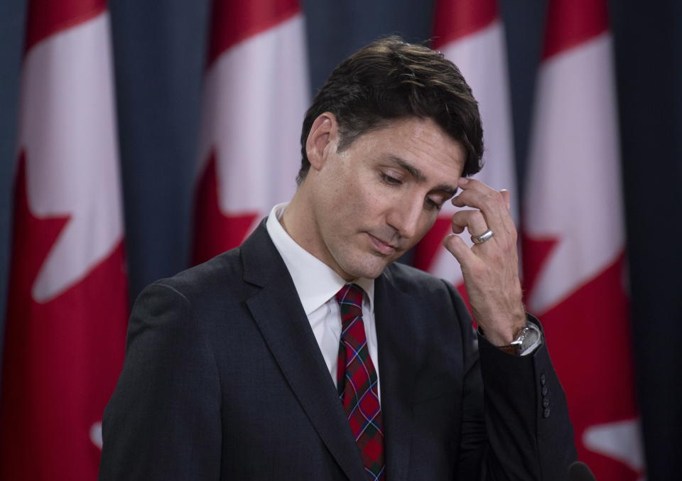 Canadian Prime Minister Justin Trudeau scratches his forehead as he listens to a question during an end of session news conference in Ottawa, Wednesday, Dec. 19, 2018. (Adrian Wyld/The Canadian Press via AP)