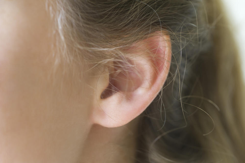 Close-up of young woman's pierced ear (Getty Images stock)