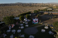 This aerial view shows Carlos Ulloa's Rancho El Refugio date palm ranch decorated for a baptism ceremony in Twentynine Palms, Calif., Saturday, June 15, 2024. Ulloa has come to appreciate date palms after buying land seven years ago in Thousand Palms. (AP Photo/Jae C. Hong)