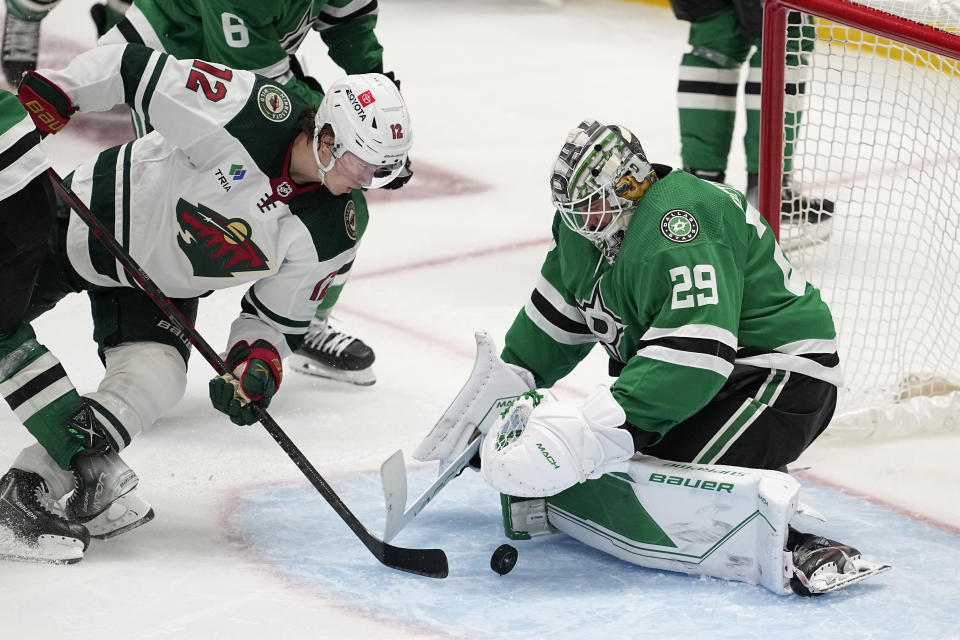 Minnesota Wild left wing Matt Boldy (12) attempts to get a shot past Dallas Stars goaltender Jake Oettinger (29) in the third period of Game 2 of an NHL hockey Stanley Cup first-round playoff series, Wednesday, April 19, 2023, in Dallas. (AP Photo/Tony Gutierrez)