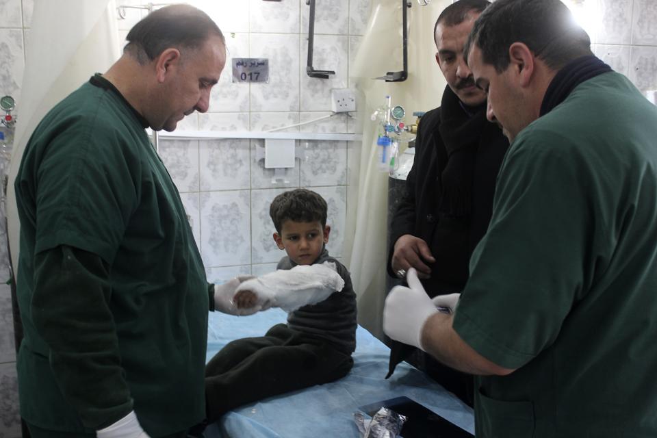 A boy who was wounded in a bomb attack receives treatment at a hospital in Baquba