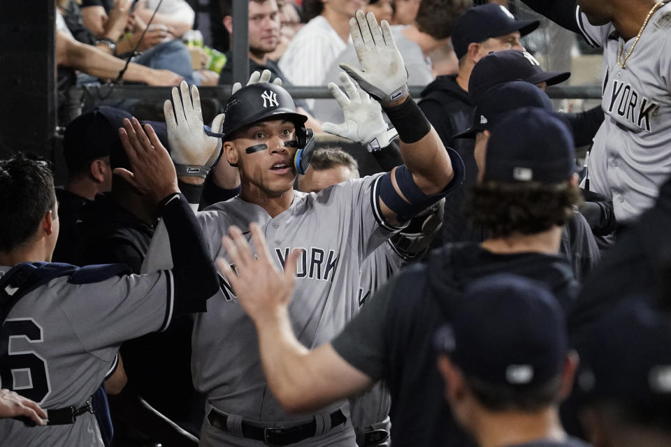 New York Yankees' Aaron Judge celebrates with teammates after hitting a solo home run during the seventh inning of the team's baseball game against the Chicago White Sox in Chicago, Thursday, May 12, 2022. (AP Photo/Nam Y. Huh)