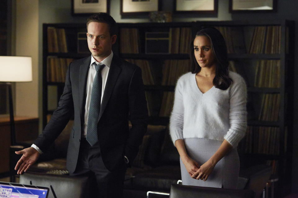 Patrick J. Adams expresses dismay, as Meghan Markle, also in distress, stands by his side.