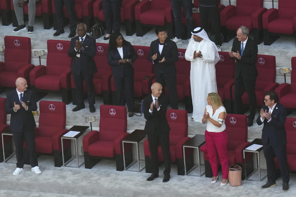 FIFA President Gianni Infantino, left, looks on as German Football Federation (DFB) President Bernd Neuendorf, centre, talks to German Interior Minister Nancy Faeser, second right, wearing the One Love armband on the tribune prior to the World Cup group E soccer match between Germany and Japan, at the Khalifa International Stadium in Doha, Qatar, Wednesday, Nov. 23, 2022. (AP Photo/Petr Josek)