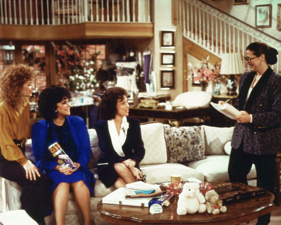 Linda Bloodworth Thomason (right) with (from left) Annie Potts, Delta Burke, and Dixie Carter on the set of <em>Designing Women</em>. (Photo: Columbia c/o Everett Collection)