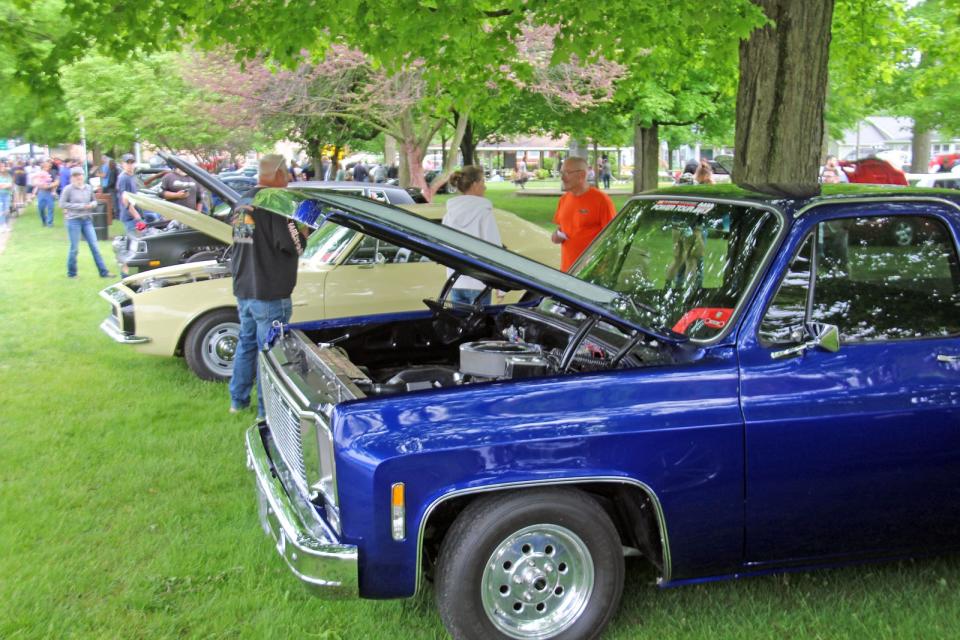 Spectators check out a number of muscle cars entered into a previous Riverfest event.